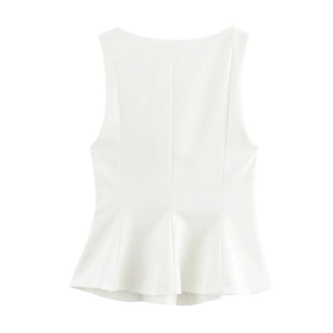 Detailed close-up of white sleeveless top showing waist pleats and hemline details