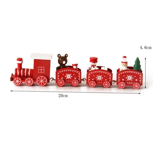 Detail view of red and white wooden Christmas train with puppets and tree miniatures
