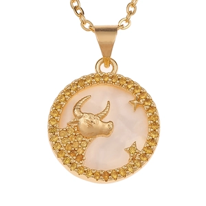 Detailed view of Taurus zodiac necklace with white shell inlay and gold plating