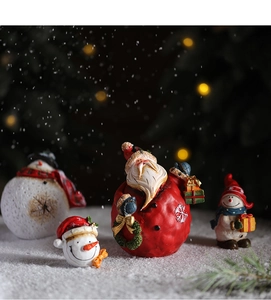 Detailed close-up of vintage resin Santa and snowman figurines in a snowy forest scene