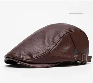 Detail of dark brown leather flat cap with lychee texture and antique gold metal buckle
