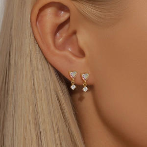 Detail view of heart-shaped moonstone and zircon drop earrings in gold plating