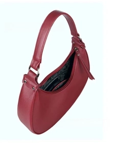 Detail view of red hobo bag showing pebbled leather texture and silver hardware rings