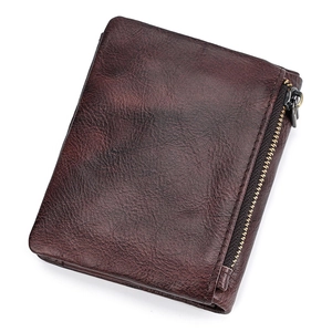 Detailed view of vintage dark brown leather wallet with metallic zipper coin pocket