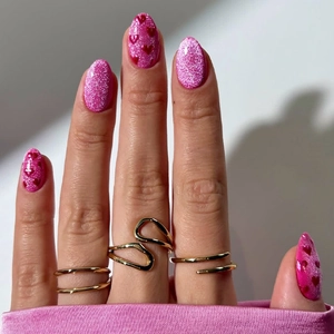 Pink cat eye press-on nails with red 3D hearts and gold minimalist geometric rings