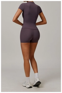 Rear view of purple seamless yoga set showing high-waisted shorts and slim-fit top fabric