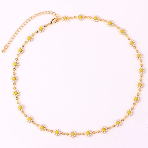 Detailed view of 18K gold plated chain with white and yellow daisy flower charms
