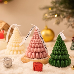 Origami Christmas tree scented candles in cream white, pink and green for holiday home decor