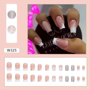 Complete set of French style press-on nails with nude base, white tips and glitter details.