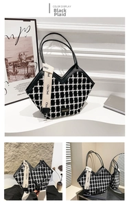 Detail of black and white plaid tote bag with V-shaped opening and stylish text ribbon
