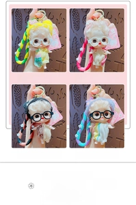 Detail showing four colorful cartoon doll keychains with knit hats and fabric dresses