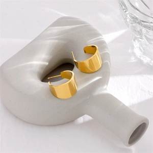 Elegant gold-tone wide C-shaped hoop earrings made of titanium steel with a sleek finish
