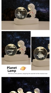Detail of 3D laser engraved crystal ball night light with astronaut base and jellyfish