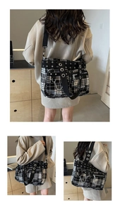 Detail of checkered punk tote with silver rivets, metal chains and wide canvas strap