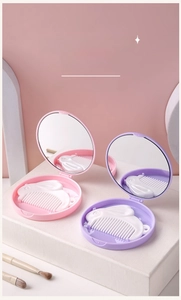 Detail of cute rabbit folding mirror and comb set in pink and purple pastel colors