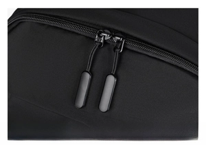 Macro view of a smooth black double zipper system on water-resistant oxford fabric