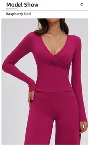 Detailed view of raspberry red long-sleeve yoga top with V-neck cross design for fitness