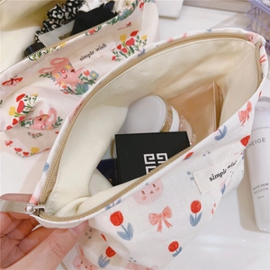 Close-up of cute rabbit and tulip canvas makeup bag showing spacious interior storage