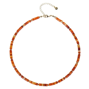 Detail of square beaded necklace with orange brown stones and golden heart pendant