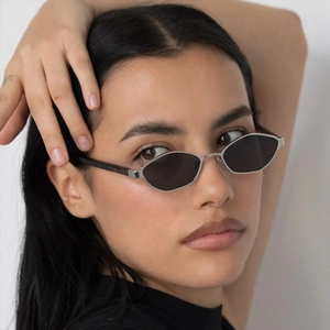 Retro polygon metal sunglasses with silver frame and dark lenses on female model