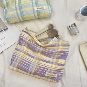Detail shot of colorful checkered toiletry bags with zipper and soft fabric texture