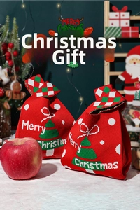 Detail of red knit Christmas knot bag featuring a festive tree pattern and Merry Christmas text