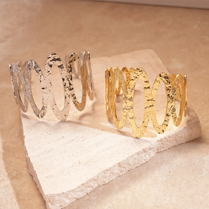 Textured hammered metal cuff bracelets with hollow oval design in gold and silver