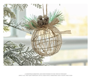 Close-up of rustic Christmas ball with burlap and pine needles on a snowy tree branch
