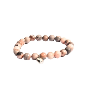 Pink zebra jasper beaded bracelet with silver heart pendant on white background