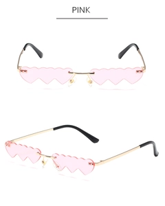 Close-up of pink gradient heart-shaped rimless sunglasses with gold metal frame and arms