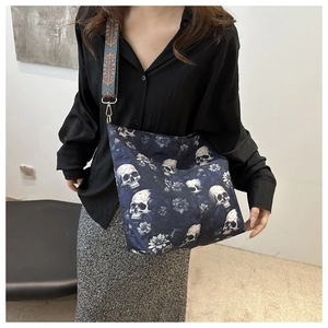 Dark blue nylon skull bucket bag with floral prints and a wide jacquard shoulder strap