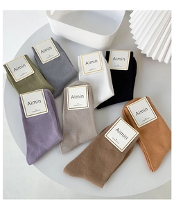 Detailed view of eight pairs of combed cotton crew socks in assorted Morandi colors