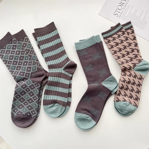 Flat lay of soft plaid cashmere-blend crew socks with vintage houndstooth and stripe patterns