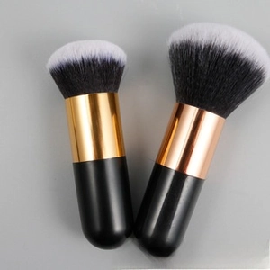 Detail of dual makeup brushes with black-white synthetic bristles and metallic ferrules