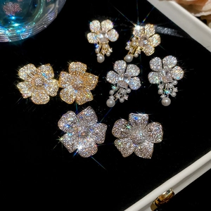 Detail view of pearl and cubic zirconia flower stud earrings in black velvet jewelry box