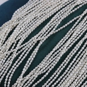 2.5mm natural freshwater white pearl strand with high luster on green velvet