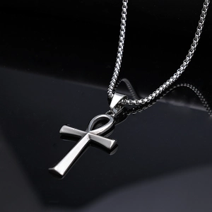 Polished stainless steel Egyptian Ankh cross pendant necklace on reflective black background