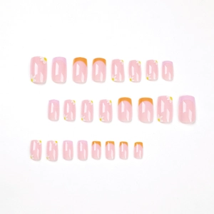 French press-on nails set with orange and pink edges featuring white daisy flower patterns