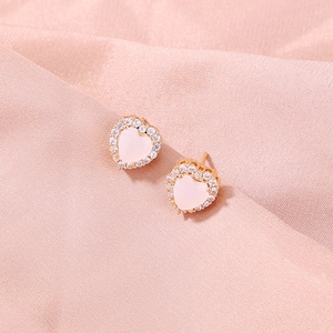 Elegant gold-plated heart stud earrings with pink gemstone and zircon on pink satin