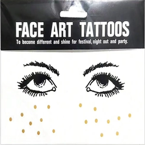 Detailed view of Face Art Tattoos packaging with gold dots and black eye patterns