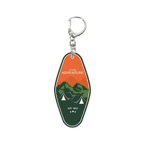 Acrylic adventure club keychain with mountain camping design on white background
