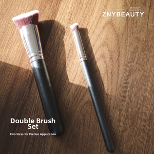 Detail of two-piece makeup brush set with dense fiber bristles and matte black handles