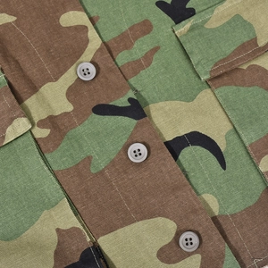 Macro detail of camouflage vest featuring high-quality twill fabric and resin buttons
