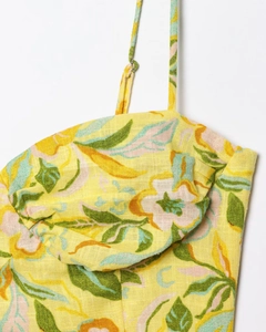 Detailed close-up of yellow floral print linen dress with adjustable spaghetti straps