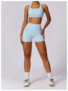 Detailed view of light blue sports bra and high-waisted shorts set in matte elastic fabric