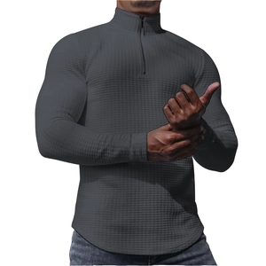 Detail of dark grey waffle knit men's pullover featuring a standing collar and quarter zip