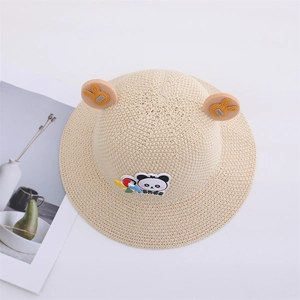 Close-up of breathable woven straw sun hat for children with 3D ears and panda patch