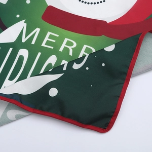 Macro detail of Christmas fabric edge with Merry Christmas print and red border