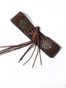 Detail of brown suede belt featuring fringe tassels and vintage engraved metal discs