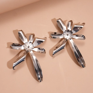 Detailed view of polished silver double-layer flower pendants with smooth metallic petals